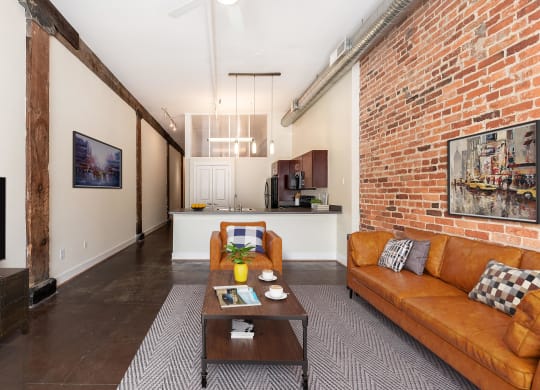 a living room with a couch and a coffee table at Mayton Transfer Lofts in Petersburg, Virginia 23803