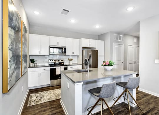 a kitchen with white cabinets and a white counter top at Farmhaus Apartments, Madison, 35757