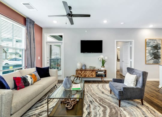 a living room with a couch and a chair at Farmhaus Apartments, Madison