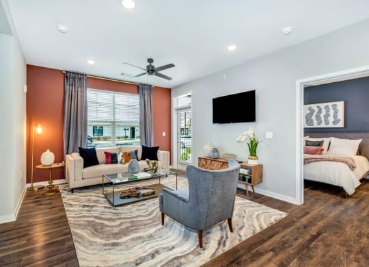 a living room with a couch and a chair at Farmhaus Apartments, Alabama