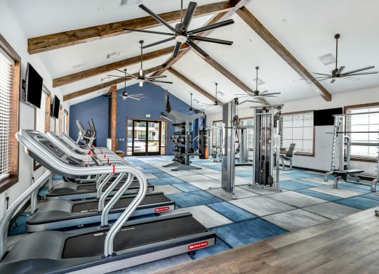 an aisle of chairs in a building with ceiling fans at Farmhaus Apartments, Alabama
