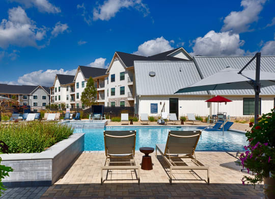 Seating by the pool at Farmhaus Apartments, Madison, AL