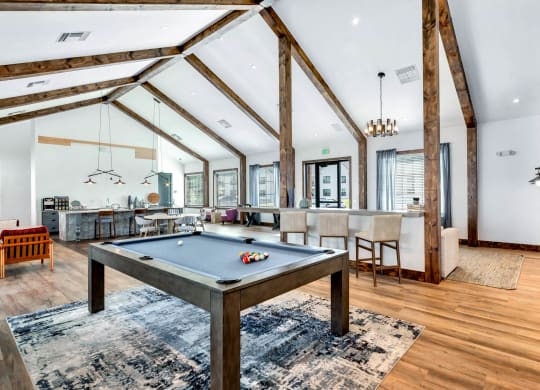 a game room with a pool table and a bar at Farmhaus Apartments, Madison