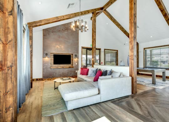 a living room with a white couch and a fireplace at Farmhaus Apartments, Madison, AL
