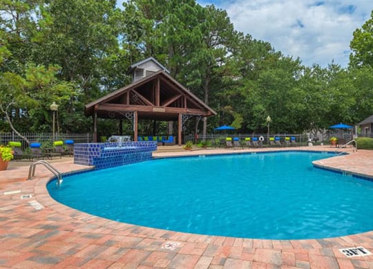 a swimming pool with a pavilion next to a resort pool  at High Ridge Apartments, Athens, GA 30606