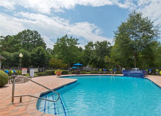 a swimming pool with a pavilion next to it at High Ridge Apartments, Athens, GA