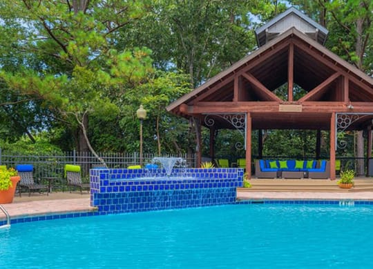 a swimming pool with a pavilion next to a pool at High Ridge Apartments, Georgia