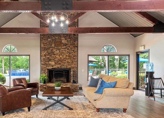 a living room with a large stone fireplace and furniture at High Ridge Apartments, Athens, 30606