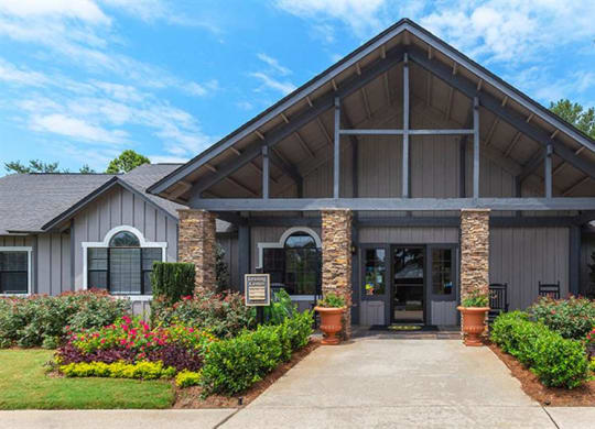 the front of a building with a sidewalk and landscaping at High Ridge Apartments, Georgia, 30606