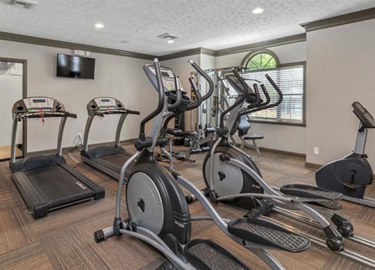 the gym is equipped with a variety of exercise equipment at High Ridge Apartments, Athens, 30606