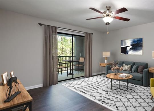a living room with a couch and a ceiling fan at High Ridge Apartments, Georgia