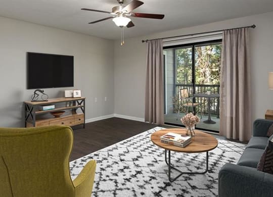 a living room with a couch and a chair and a television at High Ridge Apartments, Athens