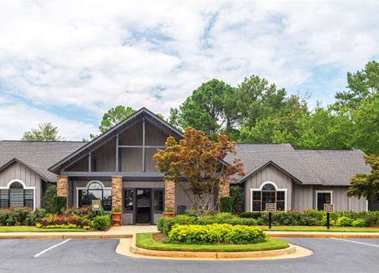 a house with a yard and a parking lot at High Ridge Apartments, Athens, GA