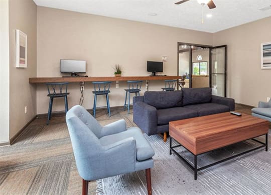 a living room with a couch and chairs and a bar at High Ridge Apartments, Athens, GA