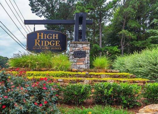 a sign for high ridge organic farms in front of a garden at High Ridge Apartments, Athens Georgia