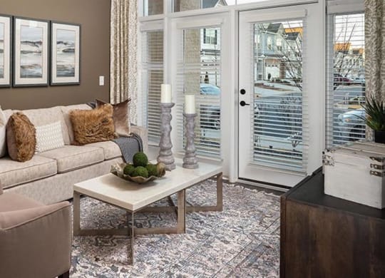 a living room with a couch and a table at The Flats at Southlawn Apartments, Georgia, 30046