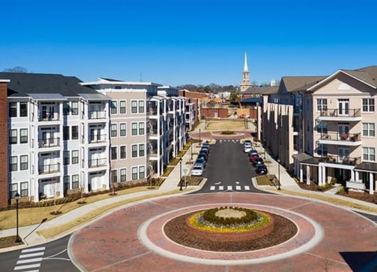 an aerial view of an empty city street with buildings at The Flats at Southlawn Apartments, Lawrenceville