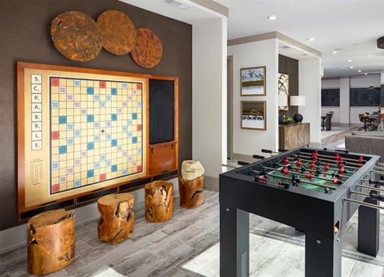 a game room with a foosball table and a board game at The Flats at Southlawn Apartments, Georgia, 30046