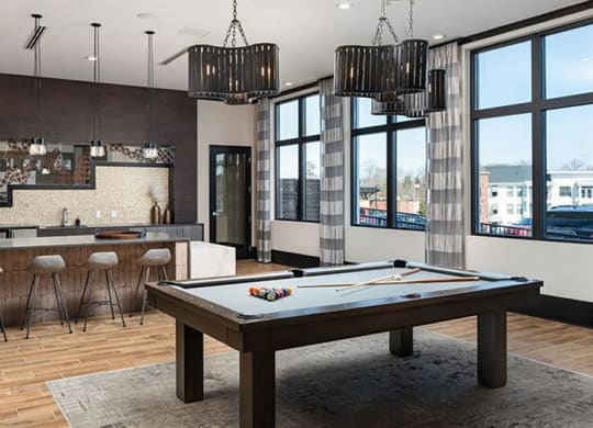a living room with a pool table and a bar at The Flats at Southlawn Apartments, Georgia, 30046