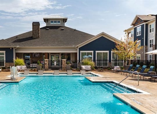 a swimming pool in front of a house at Promenade at Newnan Crossing, Newnan, GA
