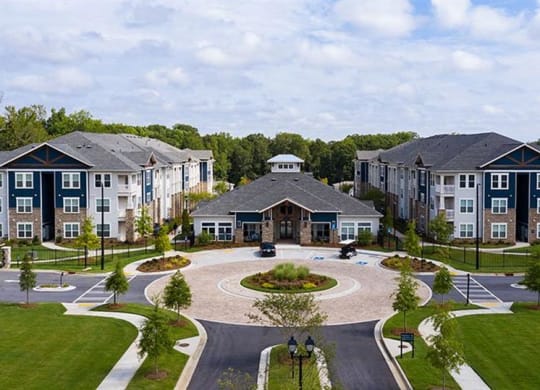 an aerial view of an apartment complex with a circular courtyard at Promenade at Newnan Crossing, Newnan, 30265