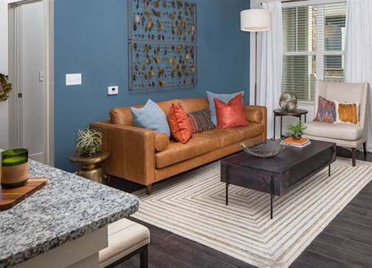 a living room with a couch and a table at Promenade at Newnan Crossing, Newnan Georgia
