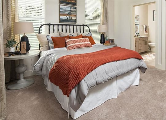 a bedroom with a bed and a bathroom at Promenade at Newnan Crossing, Georgia