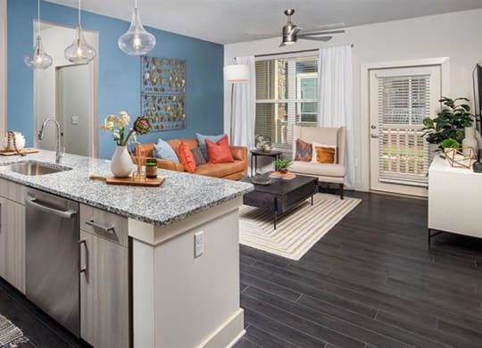 a kitchen with an island and a living room at Promenade at Newnan Crossing, Newnan, GA 30265