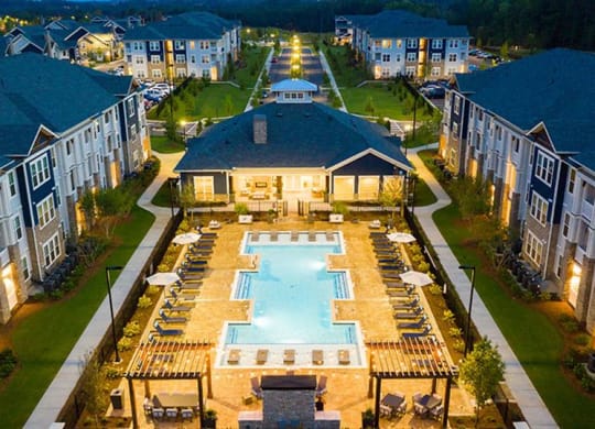 an aerial view of an apartment complex with a large swimming pool at Promenade at Newnan Crossing, Georgia