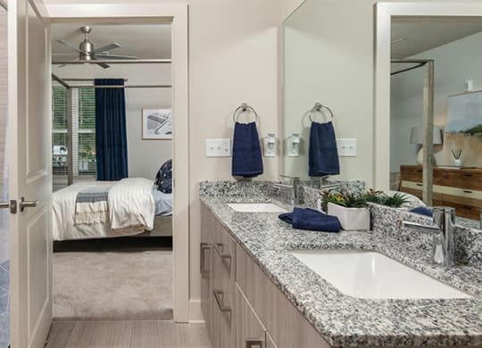 a bathroom with a tub and a sink and a mirror at Promenade at Newnan Crossing, Newnan, 30265
