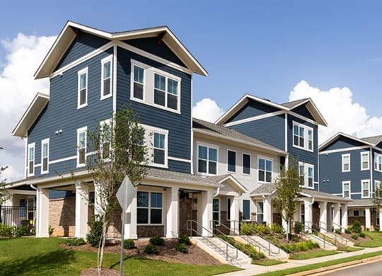 a row of houses on the side of a street at Promenade at Newnan Crossing, Newnan, GA