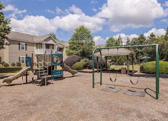 a playground with a swing set and a jungle gym at Bedford Parke Apartments, Georgia