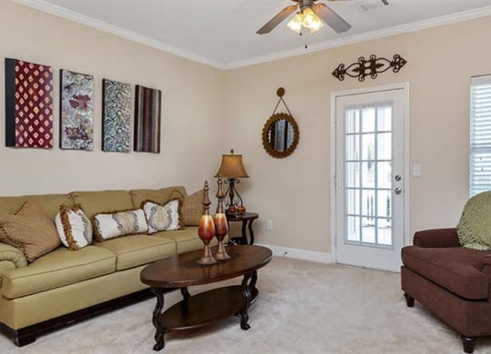 a living room with a couch and a chair at Bedford Parke Apartments, Warner Robins, GA 31088