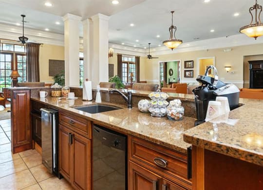 a large kitchen with a sink and a counter top at Bedford Parke Apartments, Warner Robins, GA
