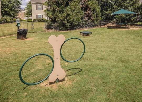 a park with a tennis racket and a hoop at Bedford Parke Apartments, Warner Robins, GA 31088