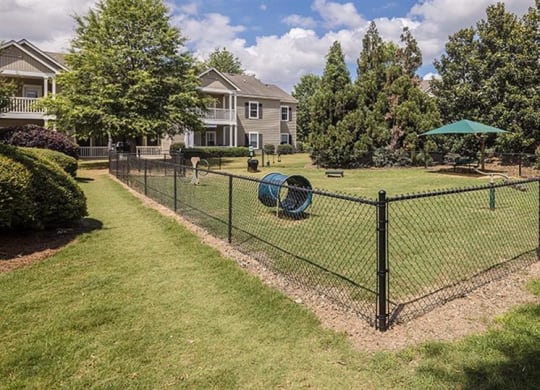 a yard with a chain link fence and a playground at Bedford Parke Apartments, Warner Robins, 31088