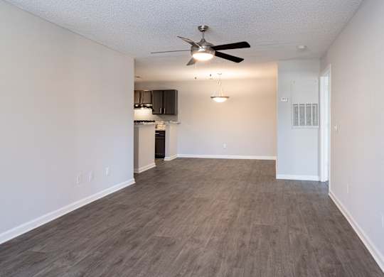 A room with a ceiling fan and a cabinet.