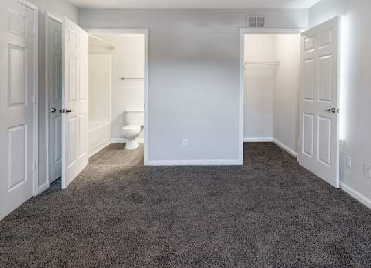 A room with carpeted floor and white walls.
