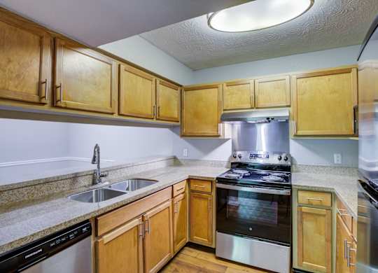 A kitchen with wooden cabinets and stainless steel appliances.