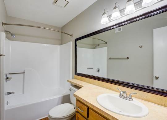 A white toilet sits next to a sink in a bathroom.