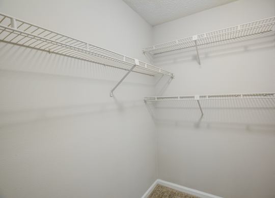 Empty white shelves in a room.