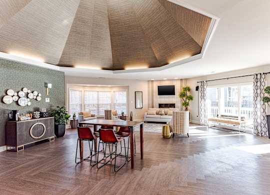 A modern living room with a wooden floor and a large window.
