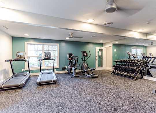A spacious home gym with a variety of exercise equipment.