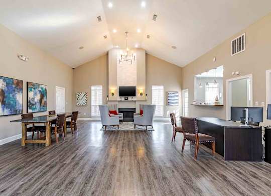 A spacious living room with a fireplace and a dining table set up.