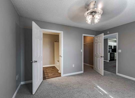 A room with a carpeted floor and a ceiling light.