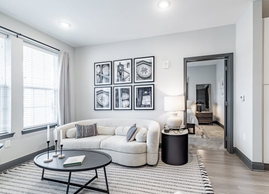 a living room with a couch and a coffee table at The Louis Apartment Flats, Louisville, KY