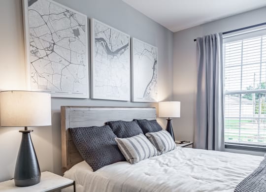 a bedroom with a large bed and a window at The Louis Apartment Flats, Louisville