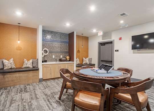 A modern dining room with a round table and chairs.