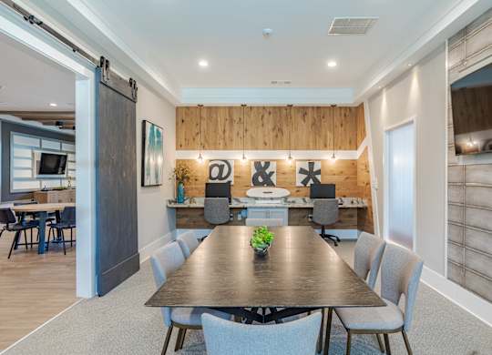 A conference room with a long table and chairs.