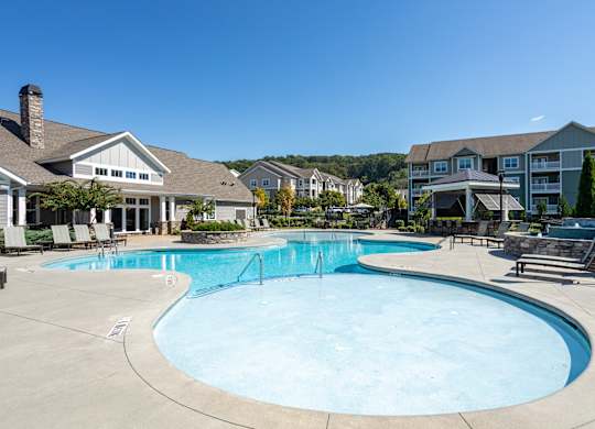 A large swimming pool in front of a resort.